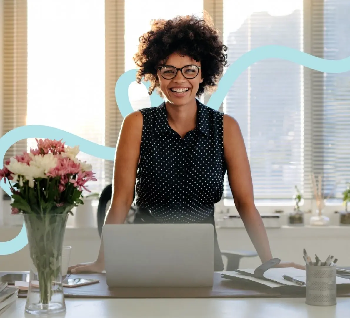 a confident professional working on a laptop in a bright workspace