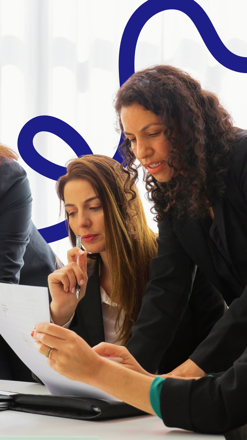 A frustrated manager sitting alone with paperwork, overwhelmed and confused by unclear or ineffective training outcomes.